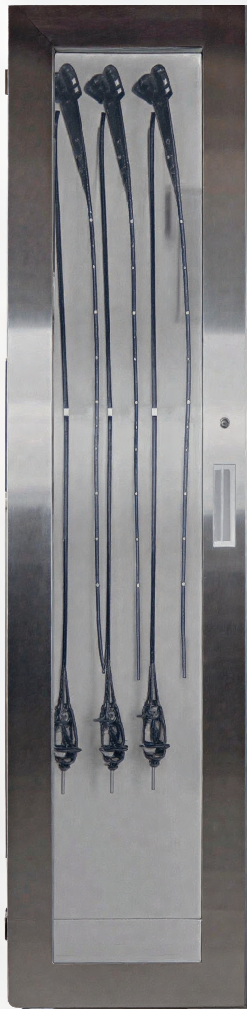 Close-up of metal elevator doors with vertical ridges and a rectangular window.