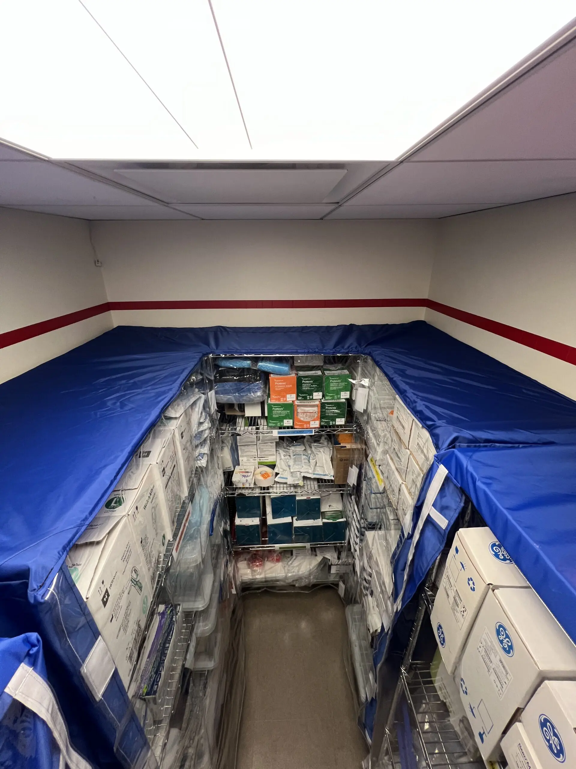 Narrow storage aisle with stacked medical supplies