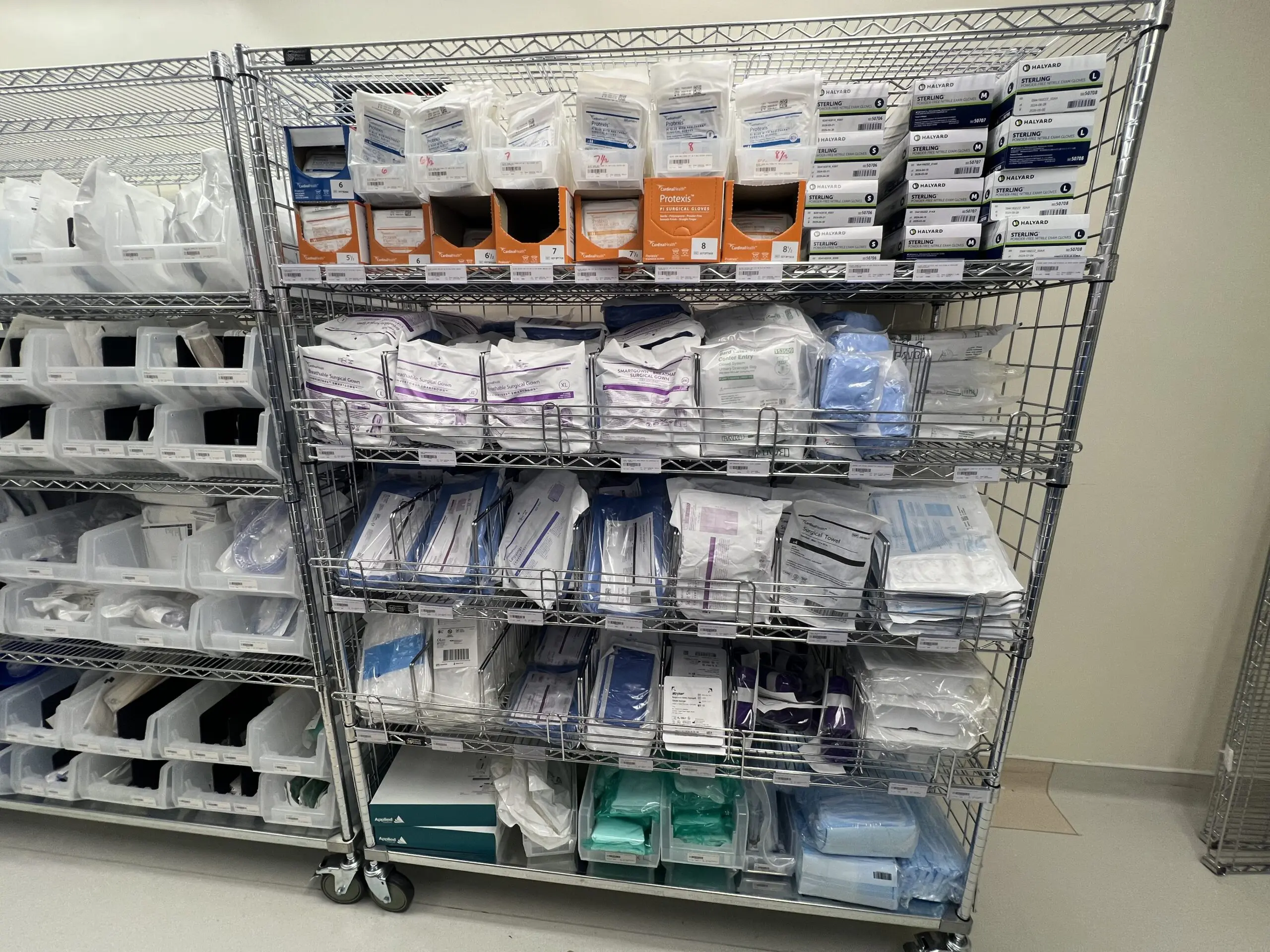 Metal shelving stocked with medical supplies and gloves