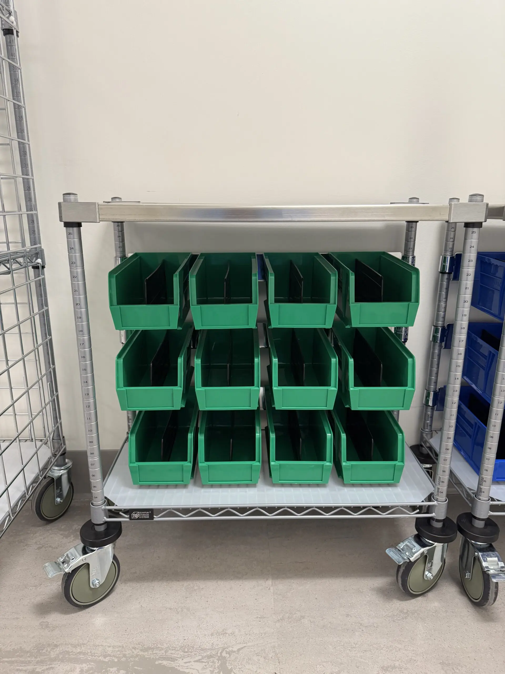 Green plastic storage bins on metal rack