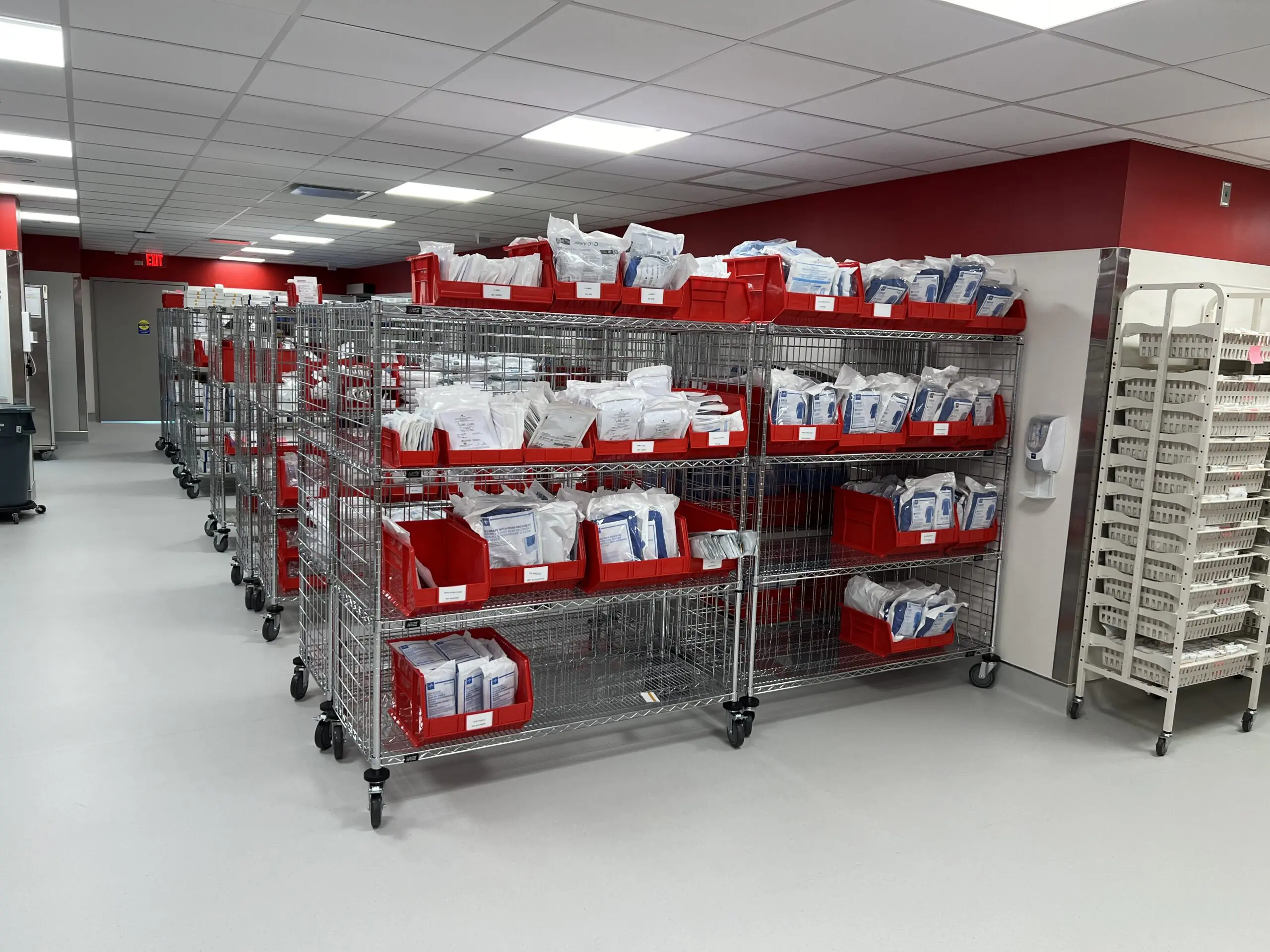 Mobile metal racks with red supply bins