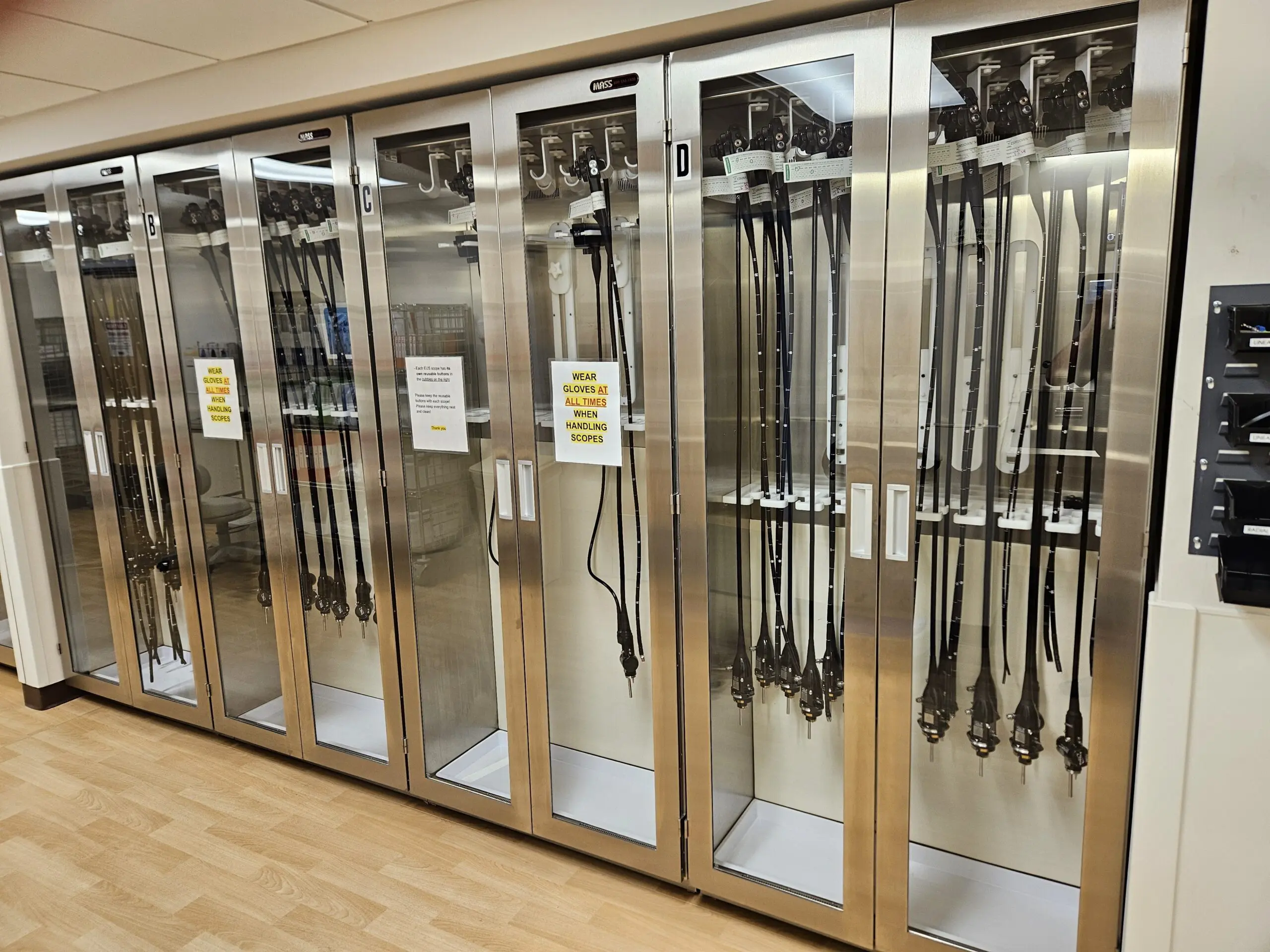 Endoscopes hanging inside glass storage cabinets