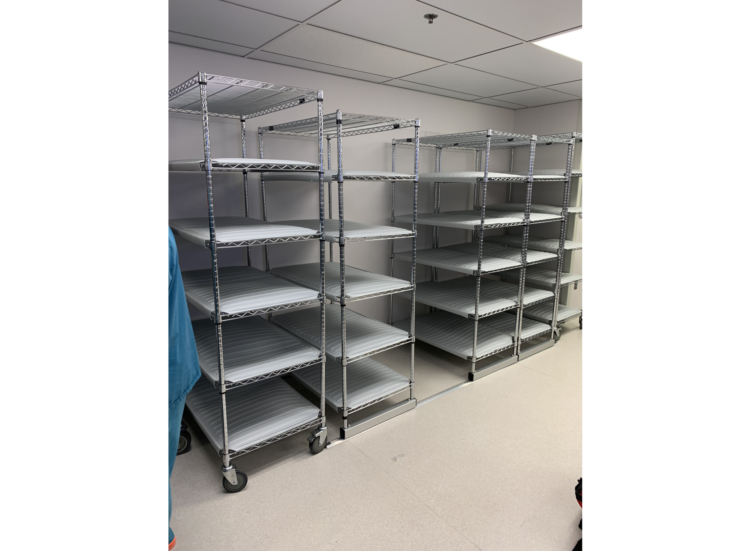 Empty metal shelving units with plastic trays