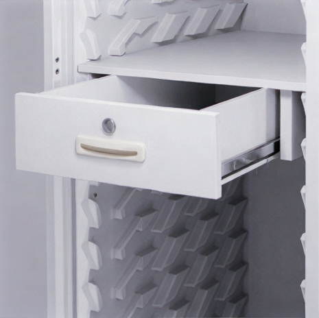Open drawer inside a textured white cabinet.