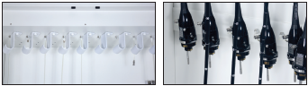 Person assembling a black wire shelving unit by attaching a shelf to a vertical pole.